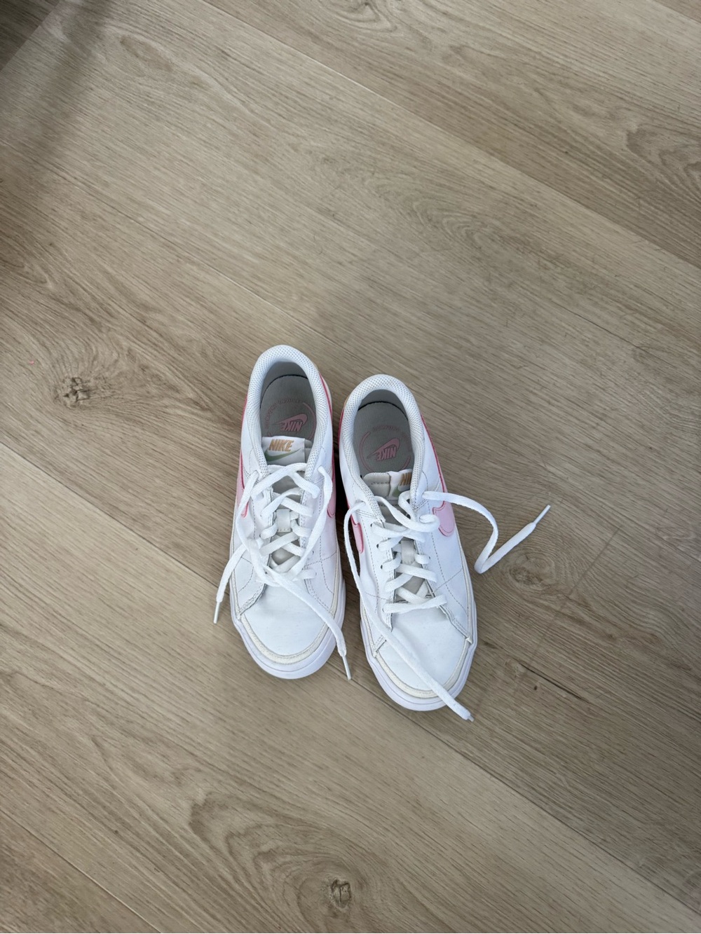Nike White Sneakers with Pink Swoosh Accent